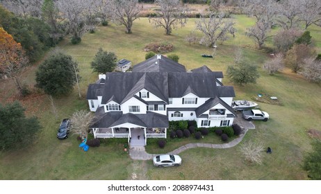 Drone overhead aerial view over large multi bedroom luxury countryside mansion real Estate featuring autumn winter and fall seasonal landscape December 8 2021 Starke Florida United States