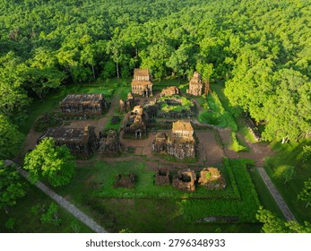Drone perspective of ancient Cham temple complex at My Son Sanctuary surrounded by dense forest in central Vietnam.