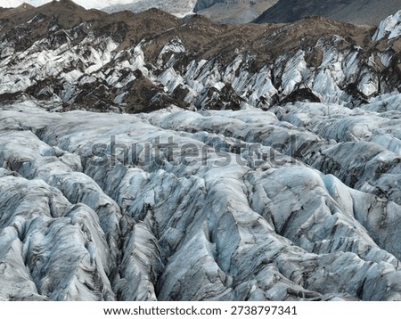 Drone perspective of sharp glacier ridges and deep natural fissures