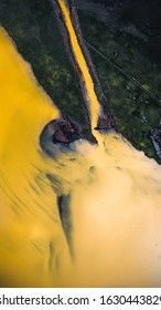 Drone Perspective Of Yellow Glacier Lake In Iceland With A Brown Riverbed. Yellow River Going Into The Ocean.