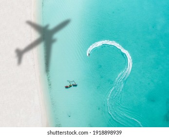 Drone photo of beach in Grace Bay, Providenciales, Turks and Caicos. The caribbean blue sea and underwater rocks can be seen, as well as some jet skies - Powered by Shutterstock