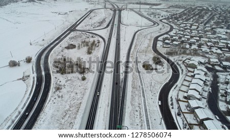 Drone photo looking down on a snowy Colorado road
