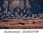 Drone photo of a person walking on rock desert near Factory Butte. Hanksville. Utah. USA