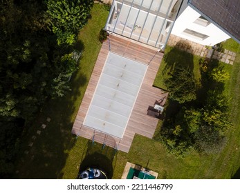 Drone Photo Of Pool Which Is Covered With Grey Pool Tarpaulin, Cover And Prepared For Winter And A Garden With House