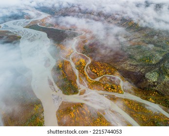 Drone Photo Of Winding River In Northern Alaska With Wispy Clouds And Fall Color