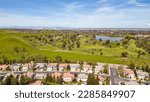 Drone photos over the city of Antioch, California on a beautiful sunny day with green hills, streets, houses, cars and solar.