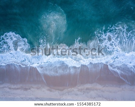 Similar – Aerial Drone View Of Blue Ocean Waves And Beautiful Sandy Beach Shore in Portugal