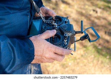 Drone pilot flying with his transmitter. Landscape image.
