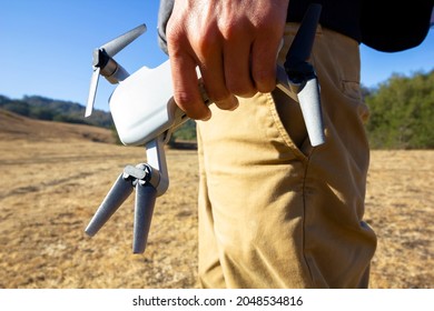 Drone Pilot Holding Small UAV In Outdoor Setting