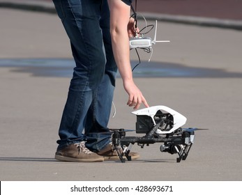 Drone pilot with the remote control turning off the drone after landing