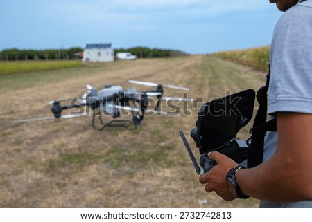 Drone Pilot With Remote Controller Over A Dry Field Ready for Aerial Survey