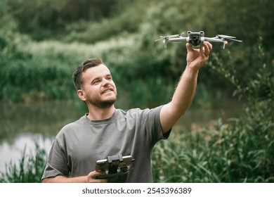 Drone pilot teacher holding UAV during outdoor lesson - Powered by Shutterstock