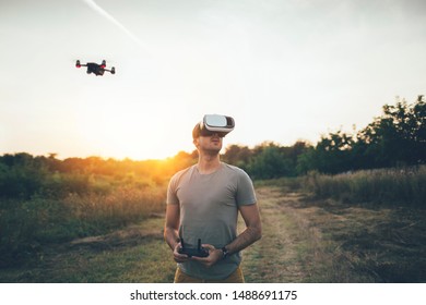 Drone pilot using drone with remote controller and virtual reality headset for making photos and videos
