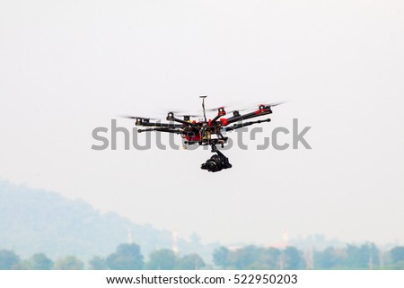 drone with professional camera flying.