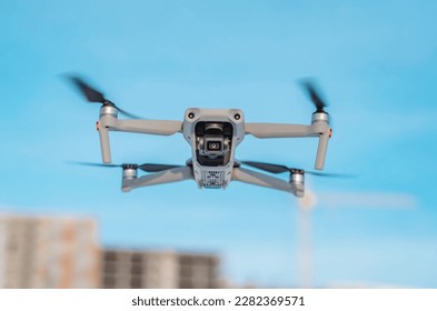 Drone quadcopter against a blue sky. Air shooting, aerial reconnaissance