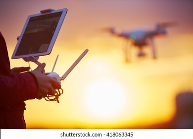 Drone Quadcopter Flying At Sunset