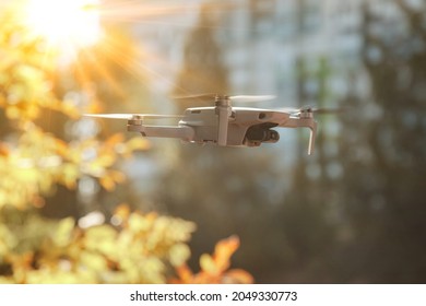 Drone Quadrocopter With Digital Camera And Sensors High Flying Controlled By Pilot. Helicopter Drone Fly Indoors. Quad Copter With Hidden Camera Spying On House And Yard. Copy Space