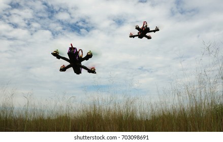 Drone Racing Over The Green Field