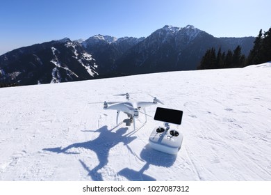 drone and remote controller on winter mountain top