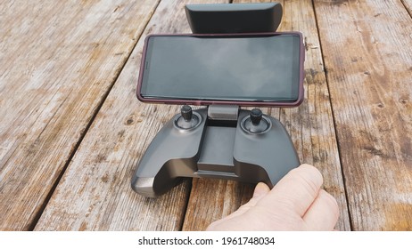 Drone remote controller with phone on the old wooden background with a copy space. 