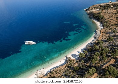 Drone scenery of tourists are enjoying a sunny summer day on a greek isolated beach with turquoise water. Tourist boat moored in the shore. Kefalonia Greek island in the Ionian sea - Powered by Shutterstock