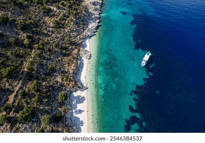 Drone scenery of tourists are enjoying a sunny summer day on a greek isolated beach with turquoise water. Tourist boat moored in the shore. Kefalonia Greek island in the Ionian sea - Powered by Shutterstock