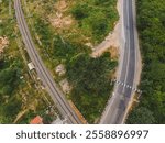 drone shot aerial view top angle panoramic photograph electric railway train track broadguage road highway tunnel mountain pass hilly kanavai valley western ghats transportation india theni-madurai