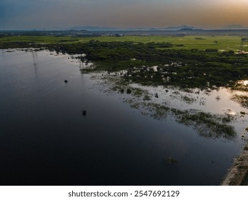 drone shot aerial view top angle sunset dusk railway track natural scenery india tamilnadu turquoise blue water wallpaper background town lake irrigation reservoir dam canal channel mountain hills  - Powered by Shutterstock