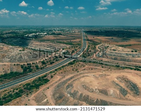 drone shot aerial view top angle bright sunny day beautiful photo national highway road bridge straight pathway wallpaper background green trees bushes 