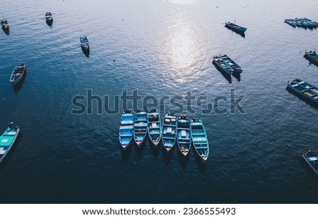 drone shot aerial view top angle panoramic photo sea ocean group of boats floating silently calm water turquoise blue sunset dawn Kerala Malabar coast india wallpaper background fishing yatch tourism