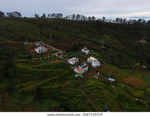 drone shot aerial\
view top angle cloudy hill station mountain valleys ghat road human\
settlement houses beautiful scenery green meadows trees grasslands\
terrace cultivation 