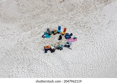 A Drone Shot Of Beach Chairs Set Up For A Group Beach Day 