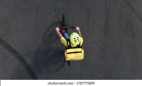 Drone Shot Of A Bicycle Messenger Riding Away