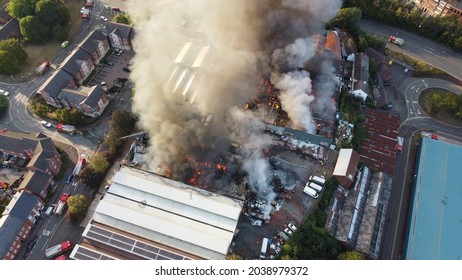 A Drone shot of a building on fire in Kidderminster, UK. High quality large warehouse fire in urban area. - Shutterstock ID 2038979372