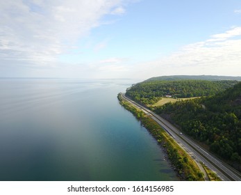 Drone Shot Of The Highway Around Vättern Sweden Bending Away From The Lake;