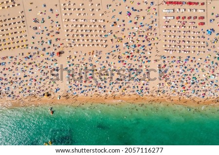 Similar – Aerial View From Flying Drone Of People Crowd Relaxing On Algarve Beach In Portugal