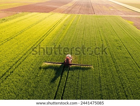 Similar – Image, Stock Photo Agriculture. Cropped shot of view businessman farmer in rubber boots walks along plowed field. Agronomist checking and analyses fertile soil on sunrise. Agribusiness.