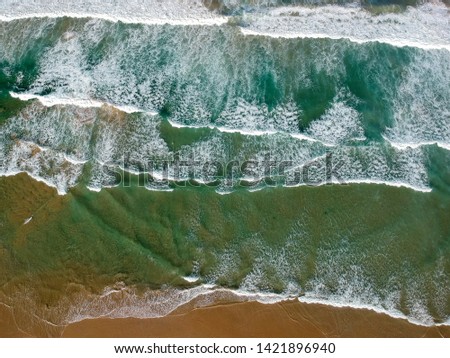 Similar – Aerial Drone View Of Blue Ocean Waves And Beautiful Sandy Beach Shore in Portugal