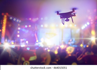 Drone Silhouette Flying Above Live Concert And Shooting Photo And Video Of Music Festival.