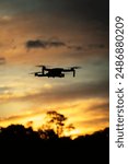 Drone silhouette at sunset fly