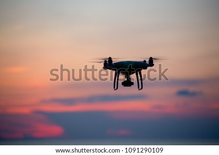 The drone in sunset sky.