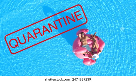 DRONE, TOP DOWN: All hotel pool party events are cancelled due to covid 19 quarantine. Young Caucasian couple relaxes on a trendy pink flamingo floatie wandering around the empty turquoise pool. - Powered by Shutterstock
