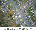 Drone top down view of typical British housing and housing estate. Most of the houses are the detached design.