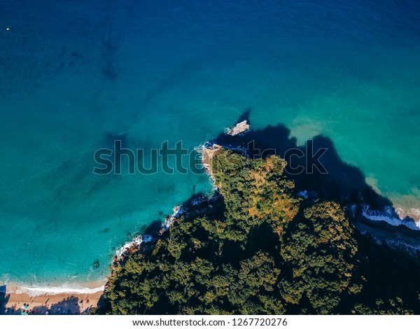 Drone top view of a\
sea cliff and a beach