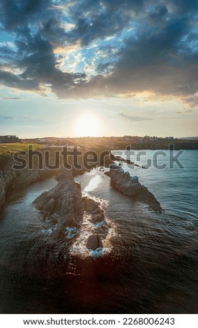 Drone top view Sunset the beach coast with rocks in foreground
