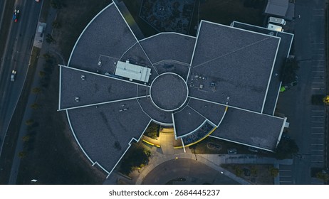 Drone top-down view of an educational facility and surrounding streets at dusk.