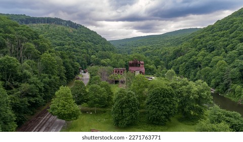 A Drone View of an Abandoned Lumber Mill, next to a River and Rail Road Tracks, in Cass West Virginia