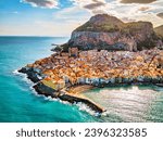 Drone view from above at the old town of Cefalu at sunset, medieval village of Sicily island, Province of Palermo, Italy. Europe. Cathedral of Cefalu