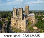 drone view Arial perspective Lincoln cathedral morning light stunning towers large medieval architecture west face sitting on hill overlooking historic city evening summer