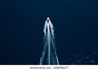 Drone View Of A Boat Sailing. Top View Of A White Boat Sailing To The Blue Sea. Motor Performance Boat In The Sea. Travel - Image. Large White Boat Fast Movement On Blue Water Aerial View.